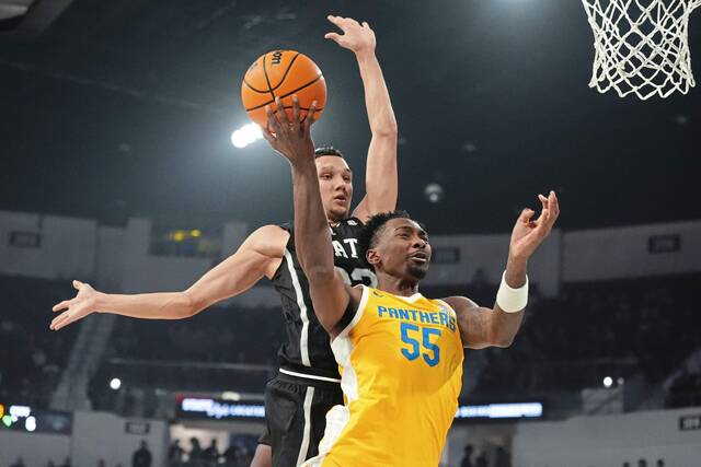 Pittsburgh forward Zack Austin (55) has an attempted layup blocked by Mississippi State forward RJ Melendez (22) during the first half of an NCAA college basketball game, Wednesday, Dec. 4, 2024, in Starkville, Miss. (AP Photo/Rogelio V. Solis)