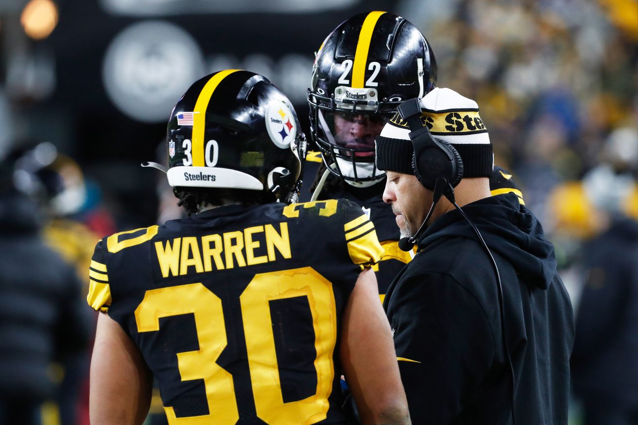 Pittsburgh Steelers running backs Najee Harris, and Jaylen Warren speak with running backs coach Eddie Faulkner during a contest against the New England Patriots from Acrisure Stadium.