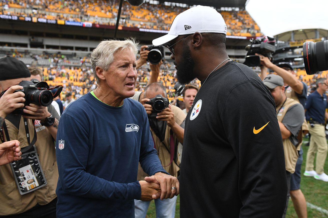 Head coach Pete Carroll of the Seattle Seahawks shakes hands with head coach Mike Tomlin of the Pittsburgh Steelers at the conclusion of the 28-26 win by the Seattle Seahawks over the Pittsburgh Steelers at Heinz Field on September 15, 2019 in Pittsburgh, Pennsylvania.