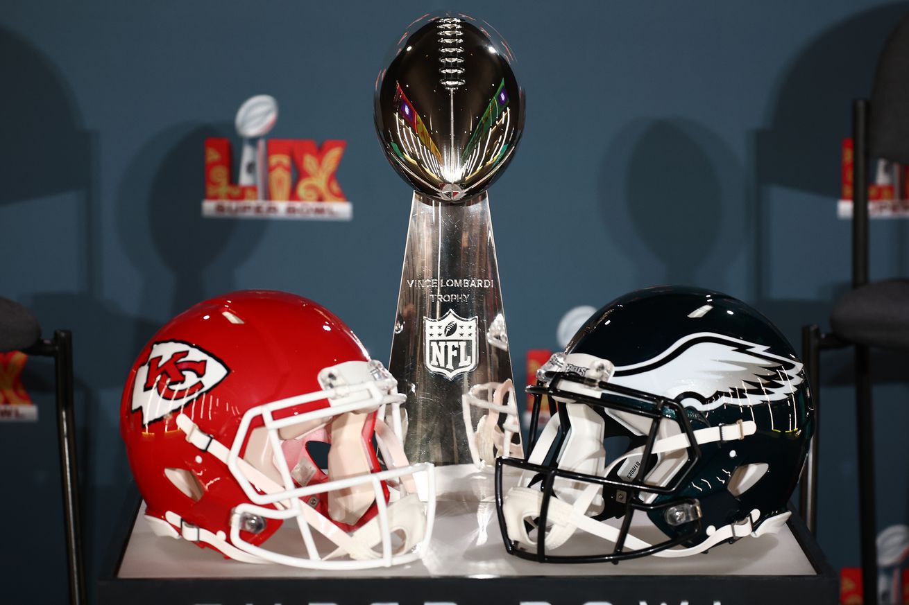 The Vince Lombardi Trophy between the 2025 Super Bowl contender Philadelphia Eagles and Kansas City Chiefs’ helmets.