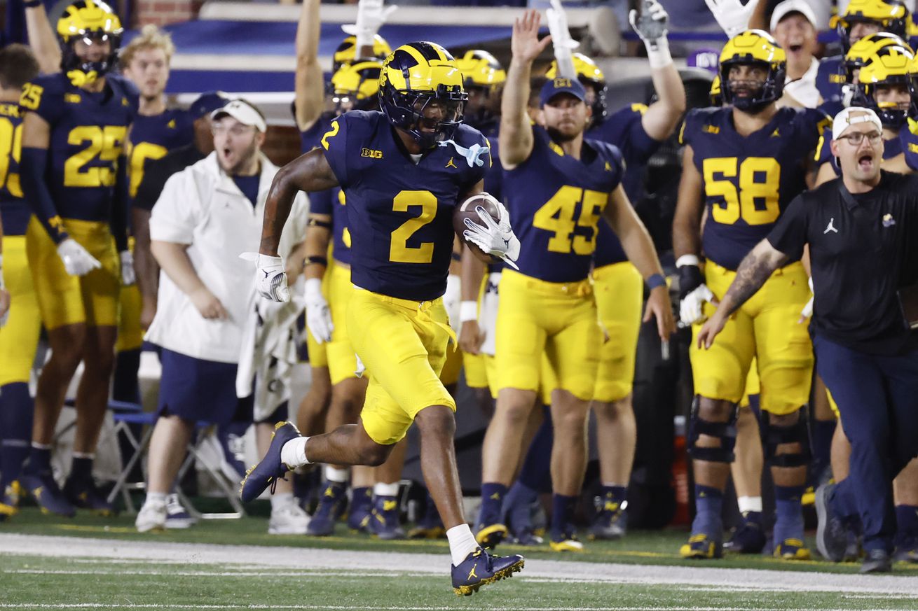 Michigan cornerback Will Johnson takes off after intercepting Fresno State’s quarterback during a 2024 contest from Michigan Stadium.